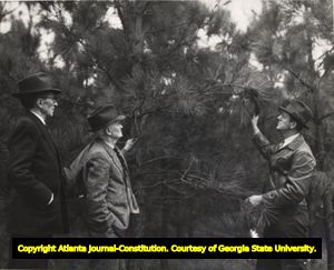 Two officers from City National Bank of Rome, discussing forest management with a Floyd County Agricultural Agent, Georgia, 1940s?