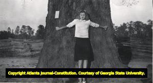 Sara Stephens stretch out against the trunk of the "Big Oak," Baker County, Georgia, 1943?