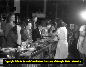 Shoppers dine at the lunch counter within a department store, 1945