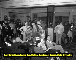 Crowded lounge area of people socializing, 1945