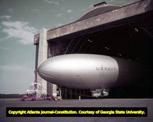 Navy blimp being directed into a hangar, 1952