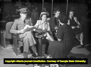 Customers wait to try on shoes at a department store, 1945