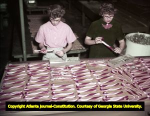 Women workers package candy canes for the holiday season, circa 1950s