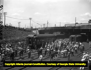 Crowds gather around President Roosevelt's arriving train, circa 1940s