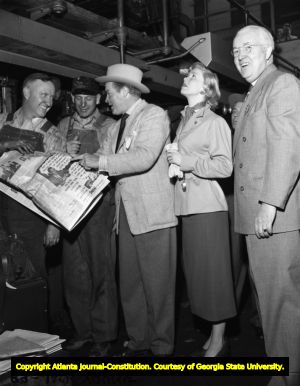 Bob Hope with Doris Day reading an article about himself, 1949