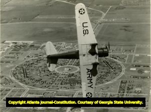 U.S. Army airplane files over a military installation, 1940.
