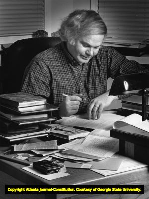 Author Pat Conroy writing at his desk, 1988