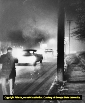 Tear gas used to disrupt the mob of UGA students violently protesting against the admittance of two African American students, 1961