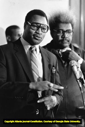 Larry Holmes and Don King during a press conference for HBO, 1986