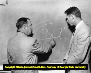 UGA Coach Butts with Bulldog player Ed Thilenius going over plays, 1950s