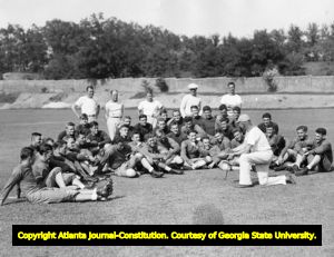 Coach W. A. Alexander of Georgia Tech talks to the Yellow Jackets during football practice, 1940s