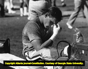 Bulldogs' Terry Hoage sits on the bench after being injured during a game, 1983