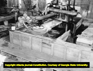Quarry worker cutting and polishing a chunk of granite, 1935