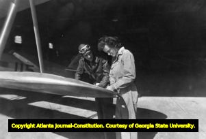 Pilot and aircraft technician assessing damage to a wing, 1940s