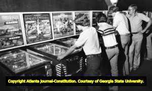 Arcade goers playing on pinball machines at a shopping mall, 1978
