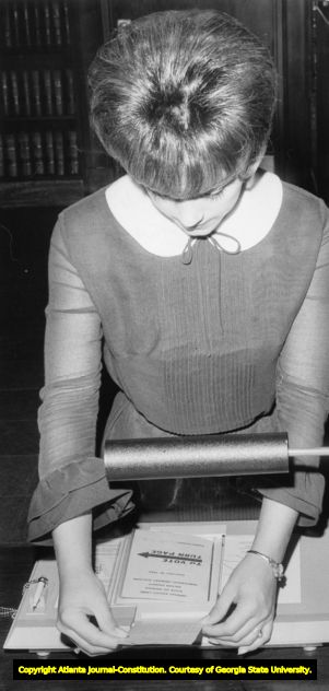 Voter selecting her choices with a paper ballot, 1966