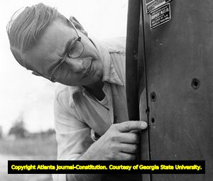 Conrad Browne shows vandalism at the integrated at Koinonia Community farm, 1957