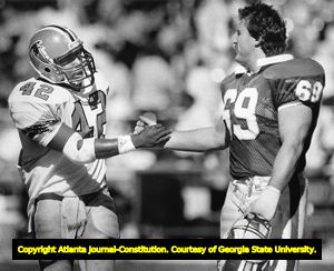 R. C. Thieleman of the Washington Redskins with former Atlanta Falcons teammate Gerald Riggs, 1987