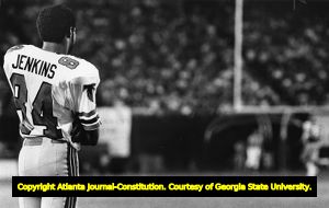 Atlanta Falcons' Alfred Jenkins watching the game from the sidelines, 1982