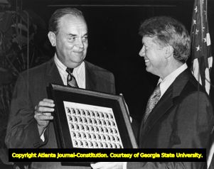 Governor Jimmy Carter with postmaster George W. Camp and a first edition sheet of drug abuse awareness stamps, 1971