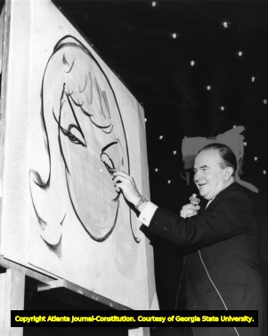 Cartoonist Milton Caniff illustrating on stage for a crowd, 1968