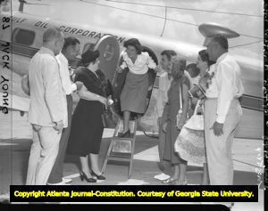 Golfer Louise Suggs at the airport with friends and family, 1948