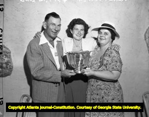 Family photo of Louise Suggs with her parents, 1947