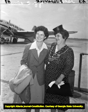 Golfer Louise Suggs with her mother at the airport, 1940s