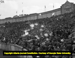 Yellow Jacket fans line Grant Field Stadium during a football game, 1939
