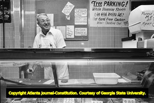 Owner Charlie Hazelrigs running the counter at Shields Market, 1978