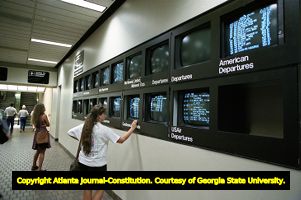 Passengers checking the departure monitors at Hartsfield International Airport, 1992