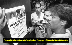 Mark Kaplan hangs missing person signs of his girlfriend Julie Love, 1988