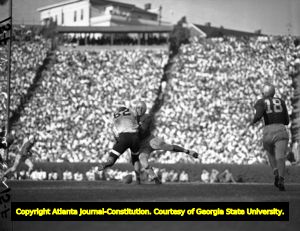 Georgia Bulldog's Charley Trippi being tackled during a game, 1940s