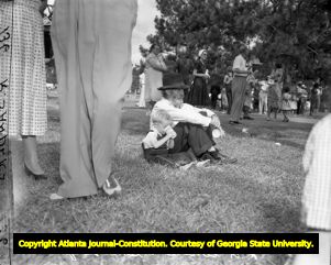 Residents gather to hear gubernatorial candidate M. E. Thompson speak at a campaign rally, 1954