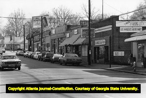 Cars parked along the storefronts in Virginia-Highland's small business district, 1980