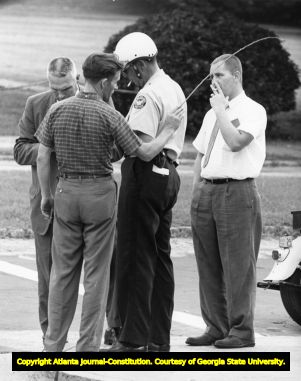 Officers at Grady High School address a disturbance with a father during the first week of integration, 1961