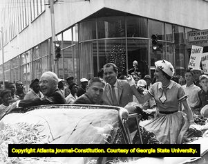 Presidential candidate Richard Nixon with wife Pat and Mayor Hartsfield during a campaign parade through Atlanta, 1960