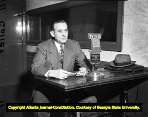 Governor M. E. Thompson preparing to broadcast over the radio, 1947