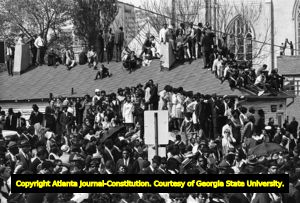 Crowds gather on rooftops near Ebenezer Church during the funeral service of Dr. Martin Luther King Jr., 1968