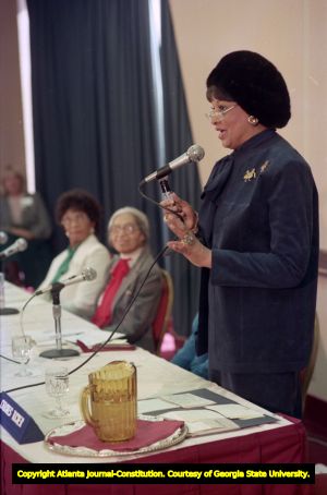 Civil rights worker DeLores Tucker speaking on a panel with Rosa parks and Linda Brown Smith during a conference, 1988