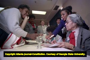 Civil rights worker Rosa Parks signing autographs after speaking at the Women and the Constitution conference, 1988