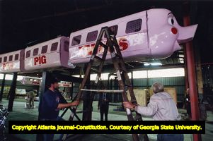 Rich's Pink Pig monorail cars undergoing maintenance for the holiday season, 1991