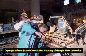 Radio DJ Will Pendarvis with unidentified worker during his late night shift at 99X, 1994