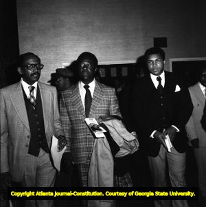 Sen. Johnson with Hank Aaron, and Muhammad Ali after a press conference, 1976