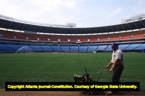 Groundskeeper Robert Johnson maintaining the Atlanta Braves baseball field, 1982