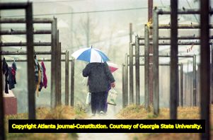 East Lake Meadows residents walking in the rain, 1991