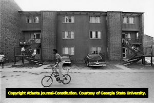Children standing outside their homes at Maynard Terrace public housing project, 1978