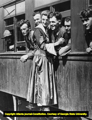 Woman saying goodbye to train of soldiers during World War I, 1910s