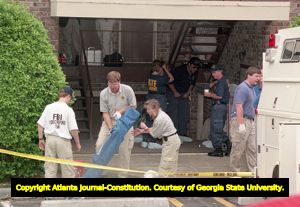 Investigators set up an area to look through potential evidence at Richard Jewell's apartment, 1996