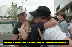 Centennial Olympic Park security guard Richard Jewell receiving a hug from a police officer after the bombing, 1996